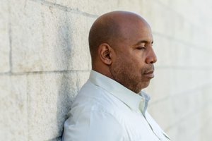 Man leans against wall thinking about treatment for mental health Houston 