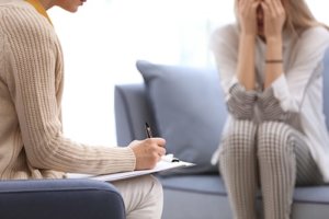 A woman sits in a therapy session as a part of a session with a Houston borderline personality disorder therapy psychiatrist